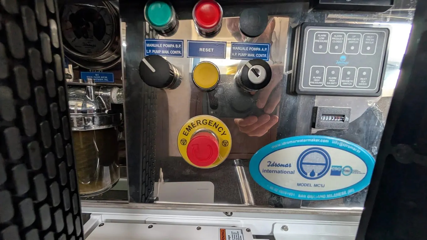 Control panel featuring emergency stop button, pump controls, and various status indicators for a water treatment system.
