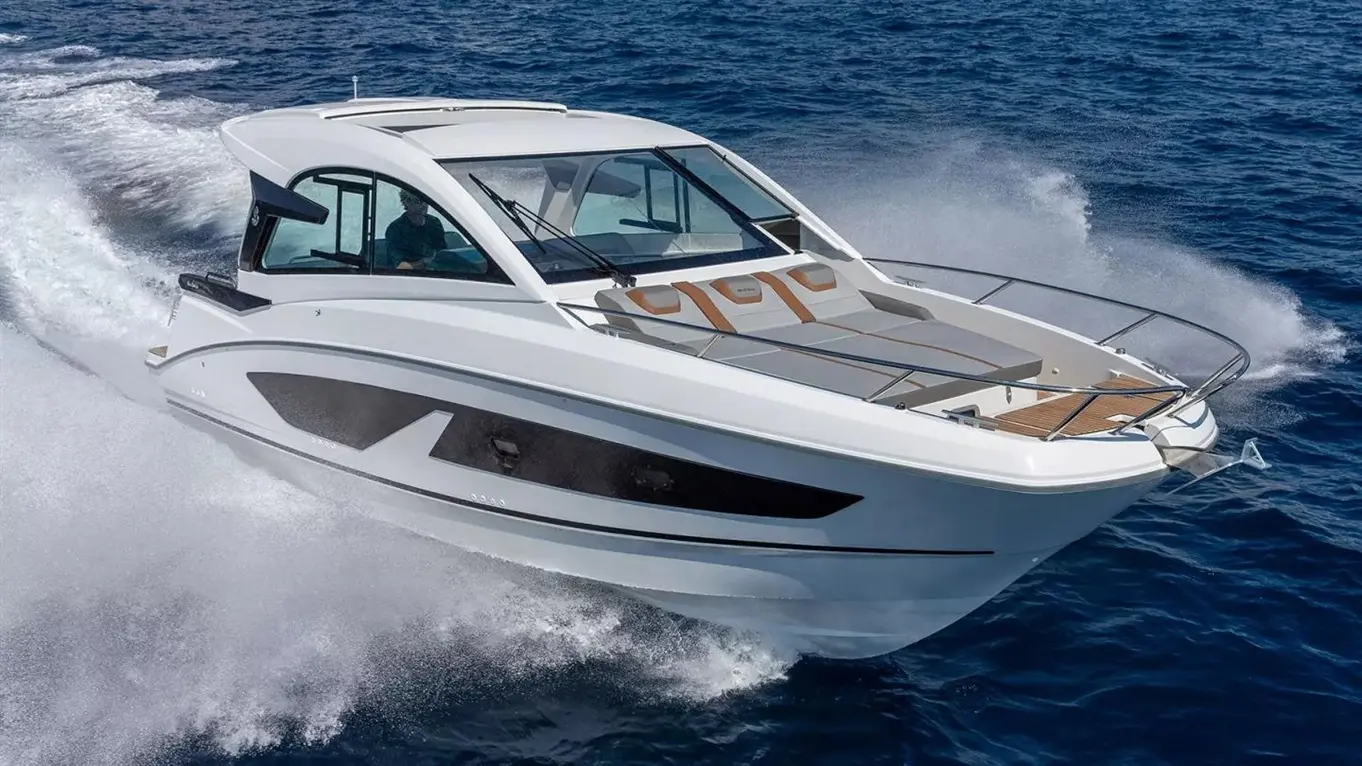 Beneteau Gran Turismo 32 motorboat speeding across the deep-blue sea, throwing up white spray.