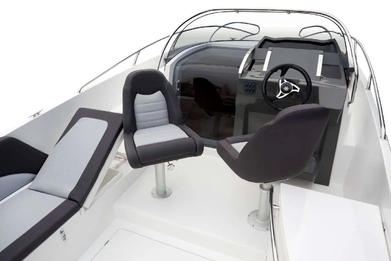 Interior of a modern boat featuring two sleek chairs, a steering wheel, and dashboard, set against a light background.