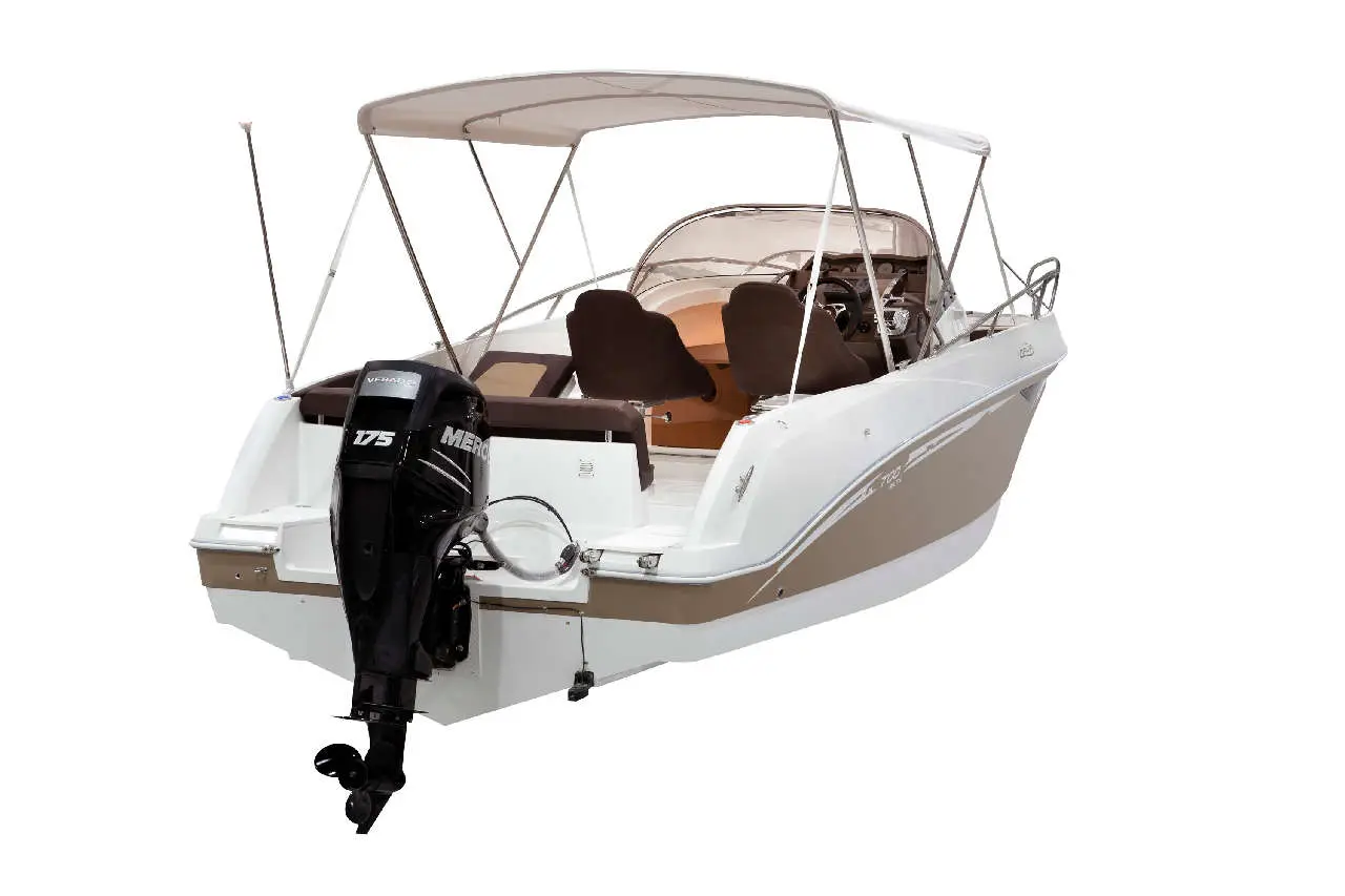 A white and beige motorboat with a Mercury 175 outboard engine, featuring seating and a canopy, ideal for leisure cruising.